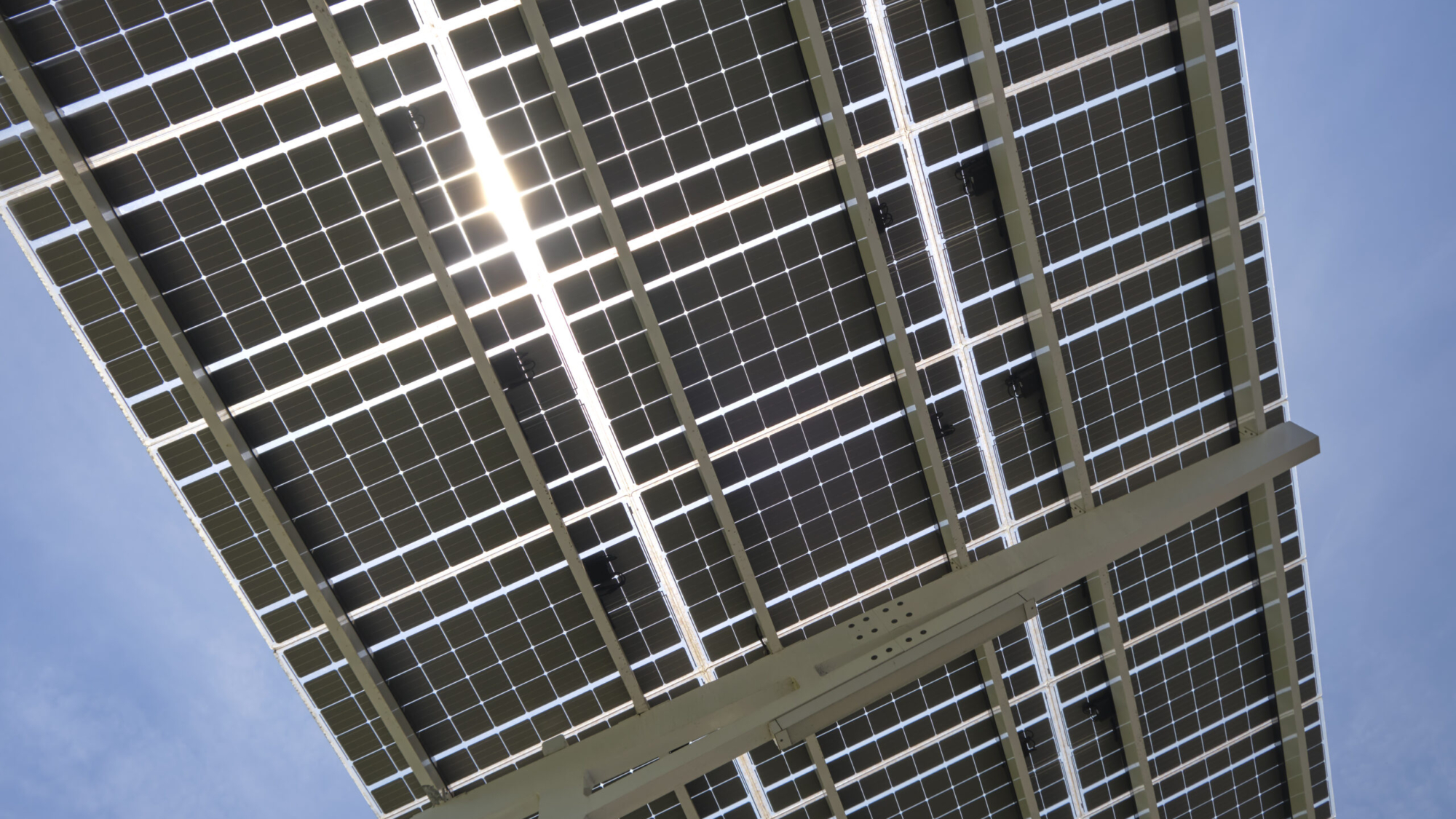 Solar panels installed over parking lot canopy shade for parked cars for effective generation of clean energy.