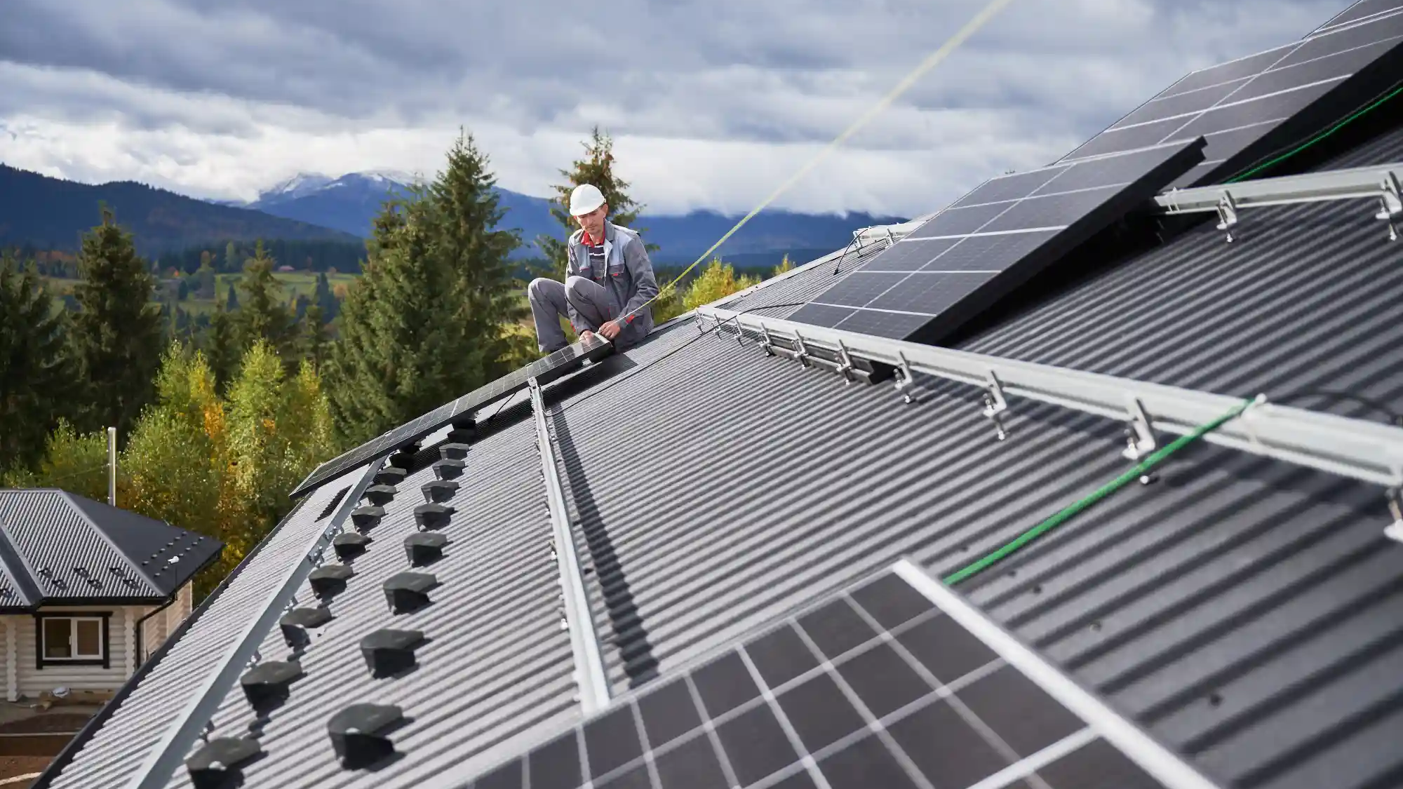 worker-making-measurements-to-secure-the-solar-pan-2023-11-27-05-04-28-utc